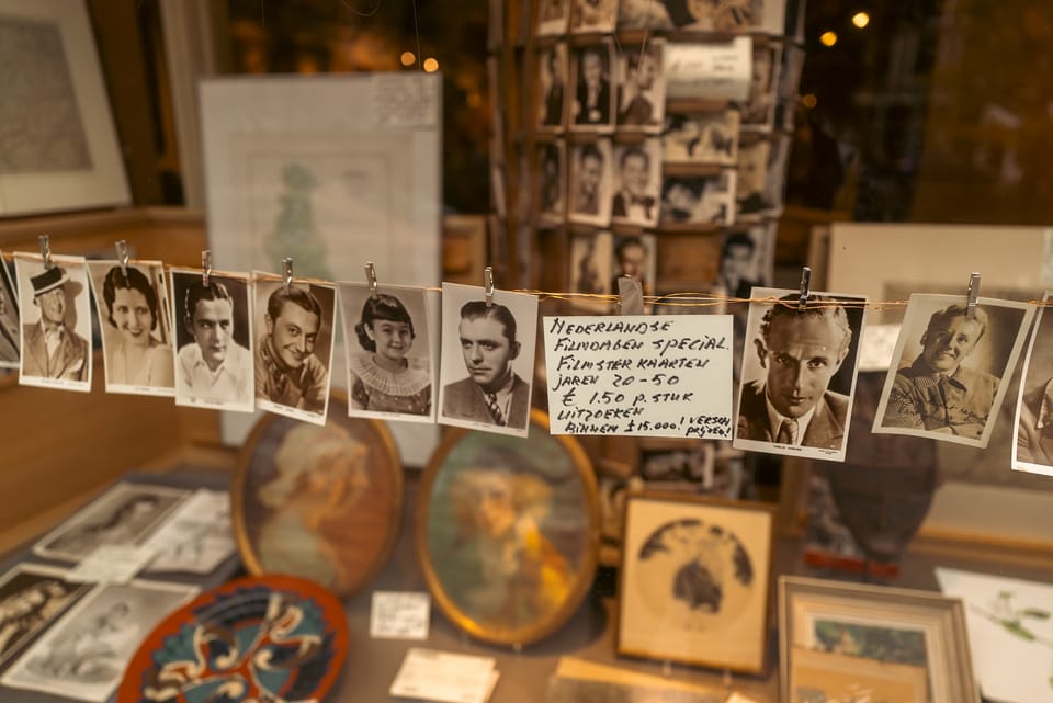 A market stall hung with vintage film-star photographs and framed prints.